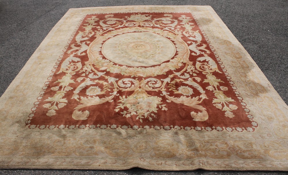 A Chinese terracotta ground carpet, 370 x 276cm